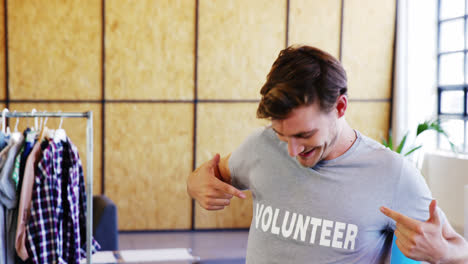 Smiling-volunteers-pointing-to-t-shirt-