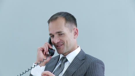Businessman-relaxing-in-office-talking-on-phone