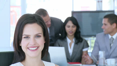 Beautiful-businesswoman-smiling-at-the-camera-in-office