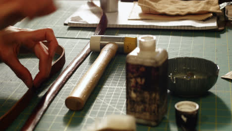Craftswoman-preparing-leather-belt