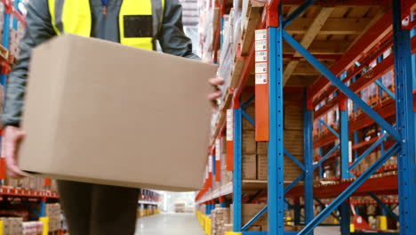 Warehouse-worker-looking-at-package