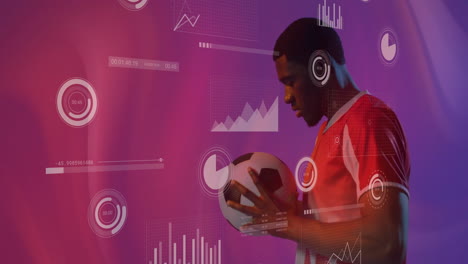 Animation-of-charts-processing-data-over-african-american-male-footballer-holding-ball-on-purple