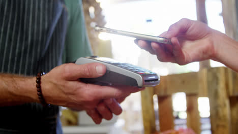 Woman-making-payment-through-smartphone