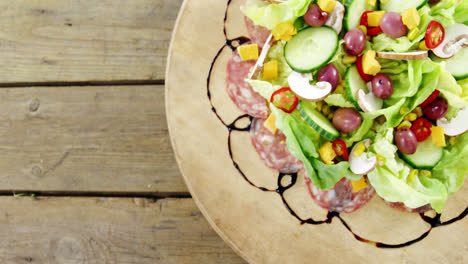 Meat-and-salad-on-wooden-plate