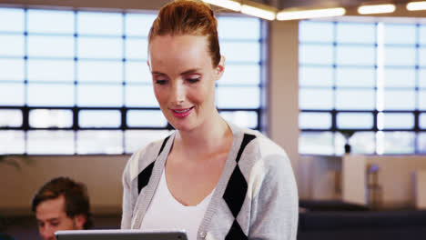 Smiling-woman-using-digital-tablet