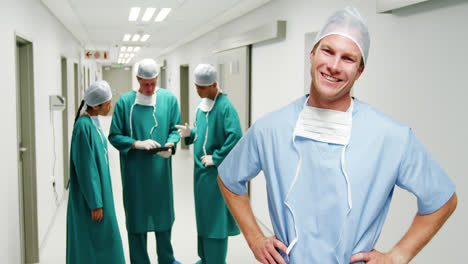 Portrait-of-male-surgeon-standing-with-hands-on-hips