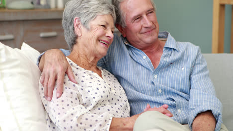 Senior-couple-embracing-in-living-room