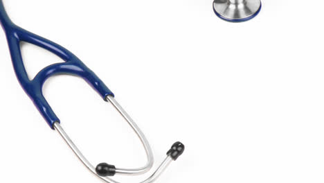 High-angle-of-a-stethoscope-turning-against-white