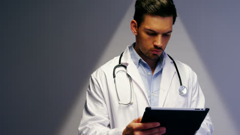 Doctor-using-digital-tablet-in-corridor