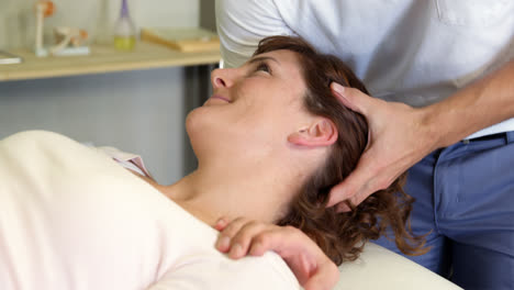 Physiotherapist-giving-head-massage-to-a-female-patient