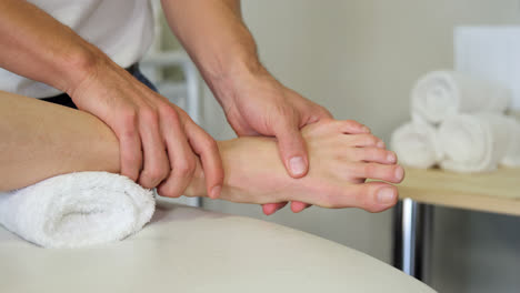 Physiotherapist-giving-foot-massage-to-a-female-patient