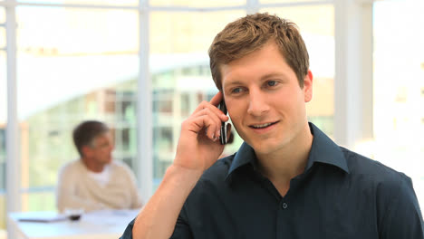 Young-man-speaking-on-the-phone