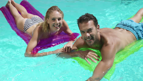 Couple-relaxing-together-in-swimming-pool