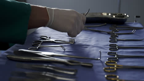 Close-up-of-surgeon-arranging-surgical-tools-on-tray