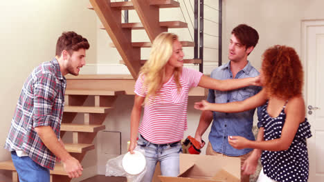 Young-lovely-couple-unpacking-boxes-while-visiting-by-friends