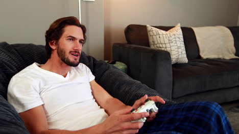Man-playing-video-games-in-living-room