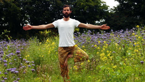 Man-performing-yoga-on-a-field
