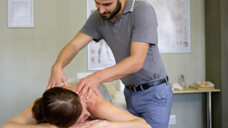 Physiotherapist-giving-back-massage-to-a-woman