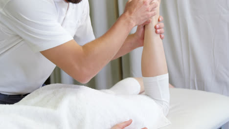 Physiotherapist-giving-hip-massage-to-a-woman