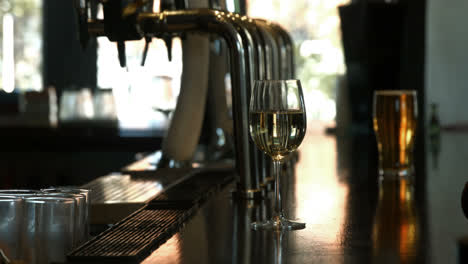 Barman-pouring-white-wine-in-wine-glass-