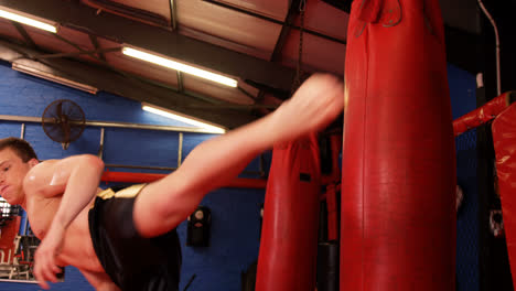 Boxer-practicing-boxing-with-punching-bag