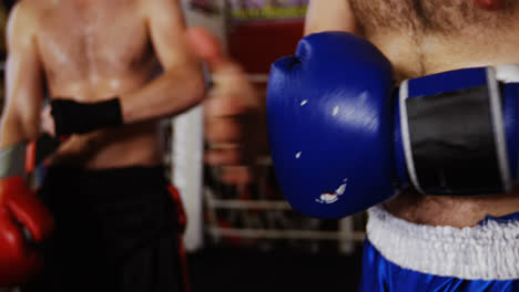 Boxers-wearing-boxing-gloves-in-fitness-studio