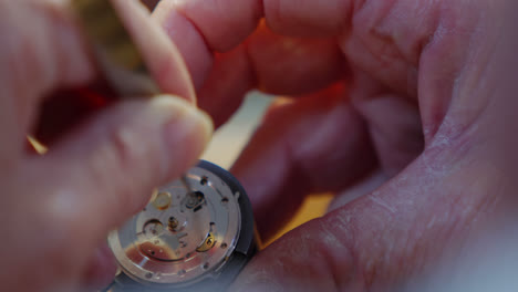 Close-up-of-horologist-hands-repairing-a-watch