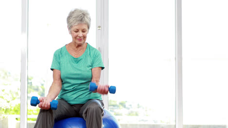 Senior-woman-sitting-on-exercise-ball