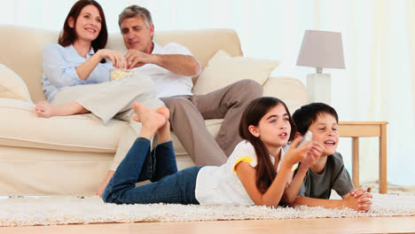 Family-laughing-in-front-of-tv