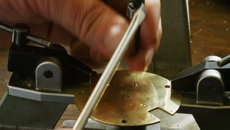 Hand-of-horologist-using-screwdriver