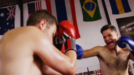 Two-boxers-practicing-in-boxing-ring