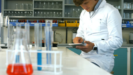 Scientist-using-digital-tablet-in-laboratory
