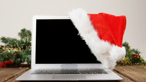 Laptop-with-santa-hat-on-a-plank
