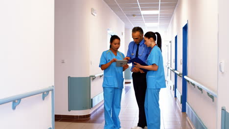 Doctor-and-nurses-looking-at-clipboard