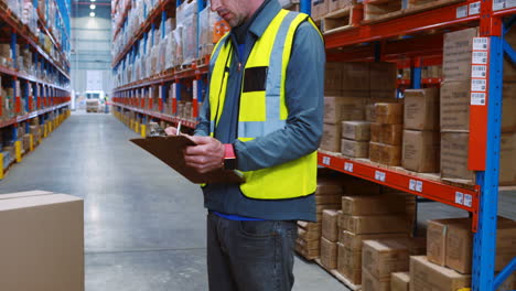 Warehouse-worker-writing-on-clipboard