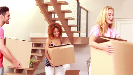 Smiling-friends-moving-boxes-together
