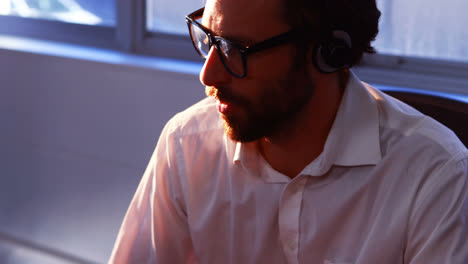 Male-graphic-designer-talking-on-headphone