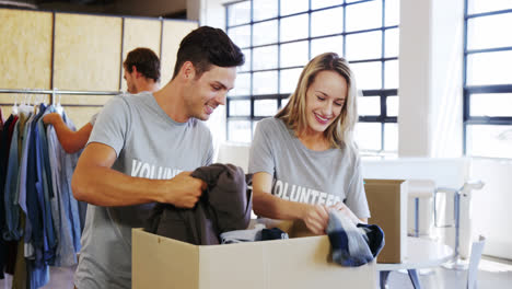 Volunteers-going-through-donation-box-of-clothes-