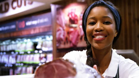 Female-staff-serving-beef-in-grocery-sections