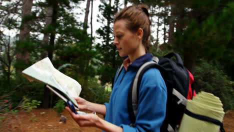 Side-view-of-hiker-walking-with-a-map-and-compass
