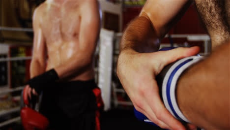 Boxers-wearing-boxing-gloves-in-fitness-studio