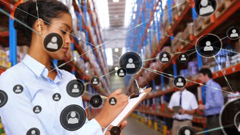 Animation-of-network-of-connections-with-icons-over-biracial-female-worker-in-warehouse