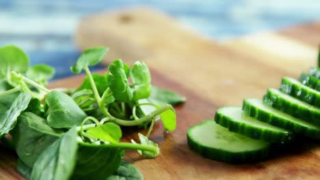 Fresh-herbs-and-sliced-cucumber-on-chopping-board