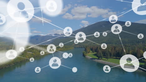 Animation-of-network-of-connections-with-icons-over-mountain-landscape