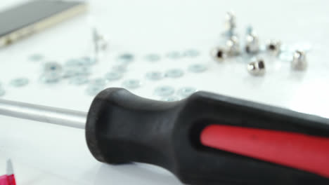 Close-up-of-screwdriver-and-screws