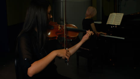 Two-women-playing-a-violin-and-piano