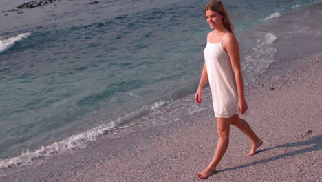 Smiling-woman-in-white-dress-walking-
