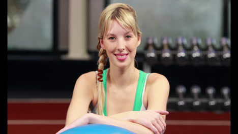 Fit-woman-smiling-at-camera-in-gym