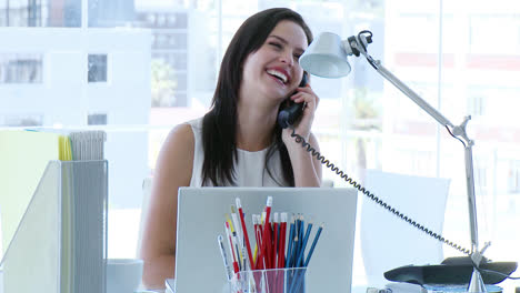 Businesswoman-working-in-office-and-talking-on-phone