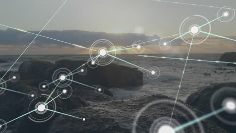 Animation-of-network-of-connections-with-icons-over-seaside-landscape